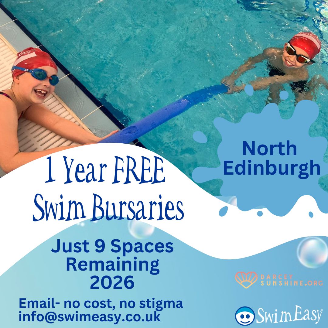 Smiling child learning to swim at Craigroyston Community High School with SwimEasy